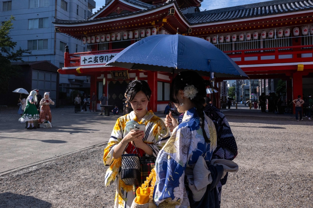 Cosplayers (left) gather at the Osu Kannon temple before the Osu Cosplay Parade, during the second day of the World Cosplay Summit 2026 in Nagoya on August 1, 2026. — AFP pic