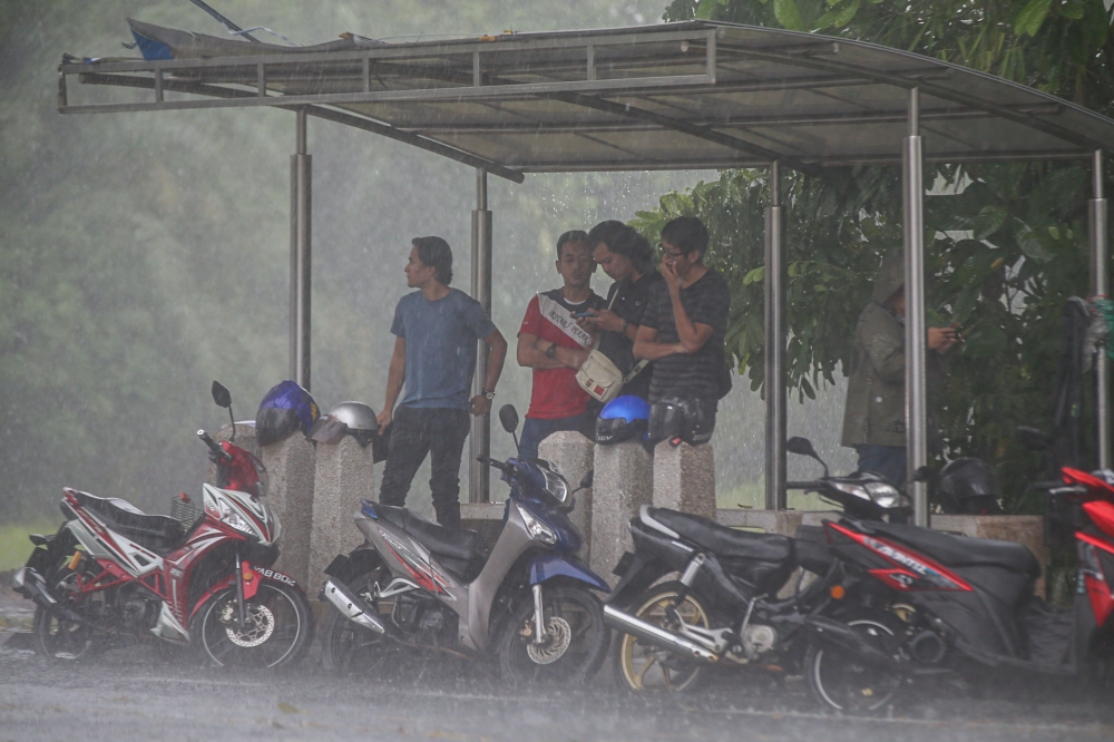Trees, gazebos, bus stops and open fields do not provide proper protection and may leave people more exposed to lightning. — Picture by Farhan Najib