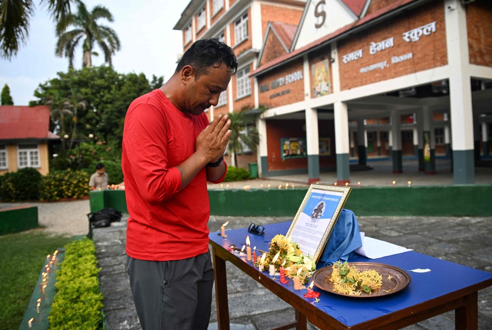Nirmal Purja’s classmate Dhiraj Bahadur Panta pays tribute to the mountaineer and nine others killed in an avalanche in Pakistan, at Small Heaven School in Chitwan on August 2, 2026. — AFP pic