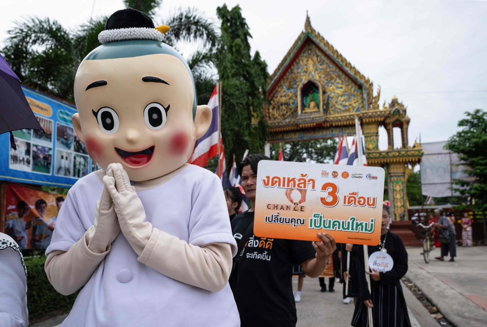 A mascot takes part in a parade encouraging people to abstain from alcohol during Buddhist Lent at Wat Nong Song Hong in Samut Sakhon province on July 30, 2026. — AFP pic