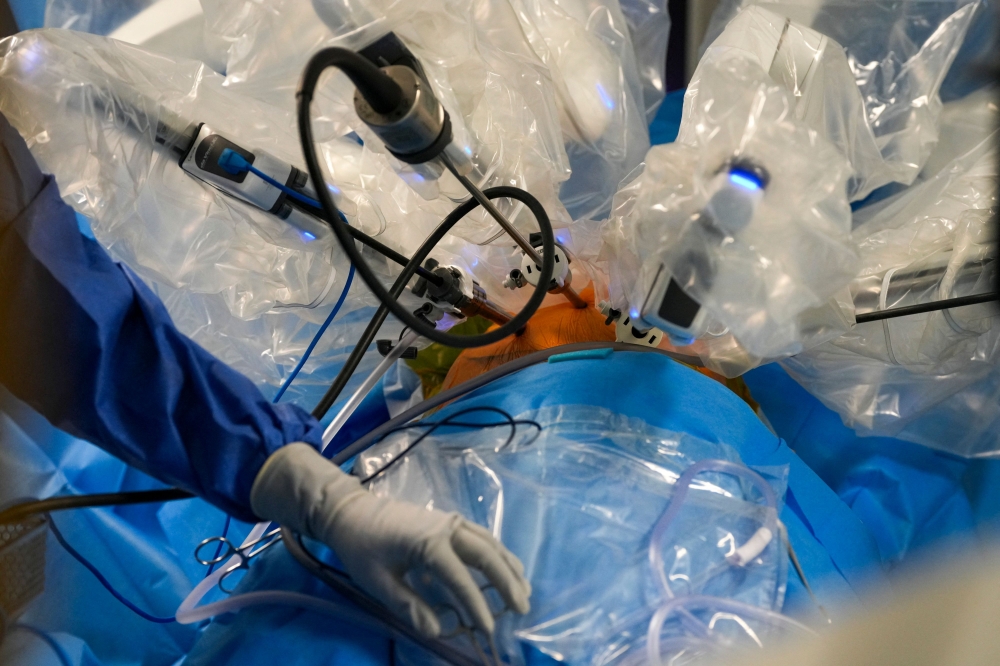 A nurse assists in lung cancer surgery using the new Da Vinci 5 robotic-assisted surgical system at St Bartholomew’s Hospital in London on July 3, 2026. — AFP pic