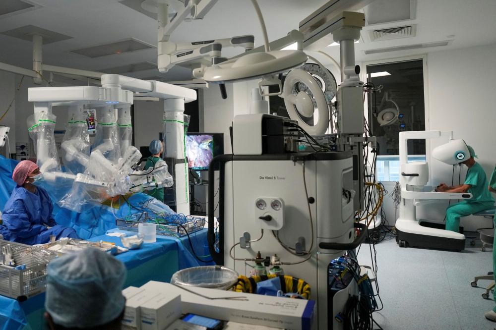 Surgeon and director of robotic surgery Sasha Stamenkovic (far right) performs lung cancer surgery using the new Da Vinci 5 robotic-assisted surgical system at St Bartholomew’s Hospital in London on July 3, 2026. — AFP pic