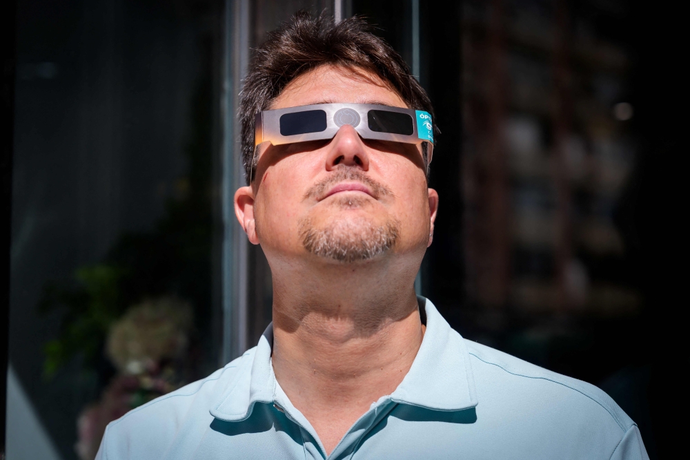 An information panel displays measures on how to safely view an upcoming solar eclipse on a street in Palma de Mallorca on July 31, 2026. — AFP pic