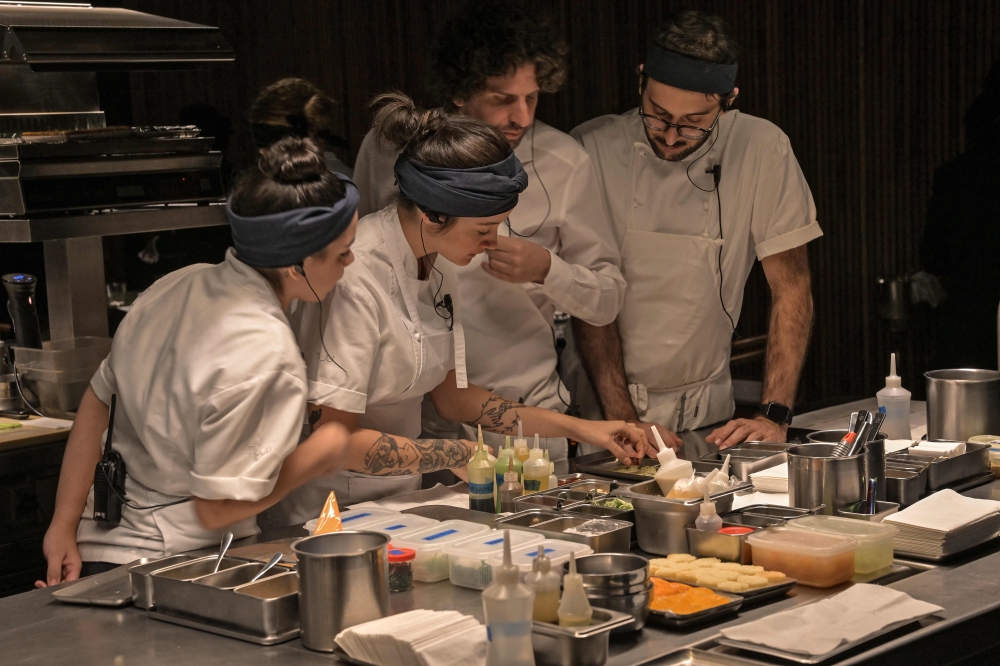 Tuju owner Ivan Ralston (second right) works with chefs in the kitchen of the three-Michelin-star São Paulo restaurant. — AFP pic