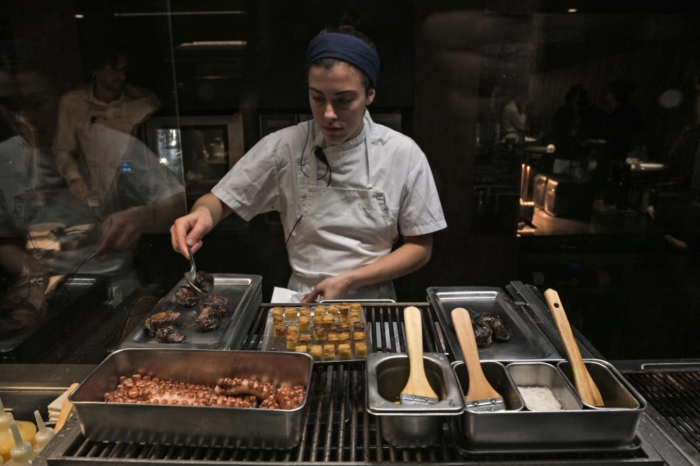 A cook prepares dishes at Tuju, the first three-Michelin-star restaurant in Latin America. — AFP pic