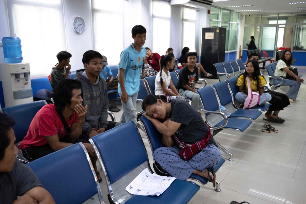 Karen refugees from the Mae La refugee camp along the Thai-Myanmar border wait inside a district office to register for Thai ID cards issued to foreigners granting them permission to work, in Prachinburi province on July 1, 2026. — AFP pic
