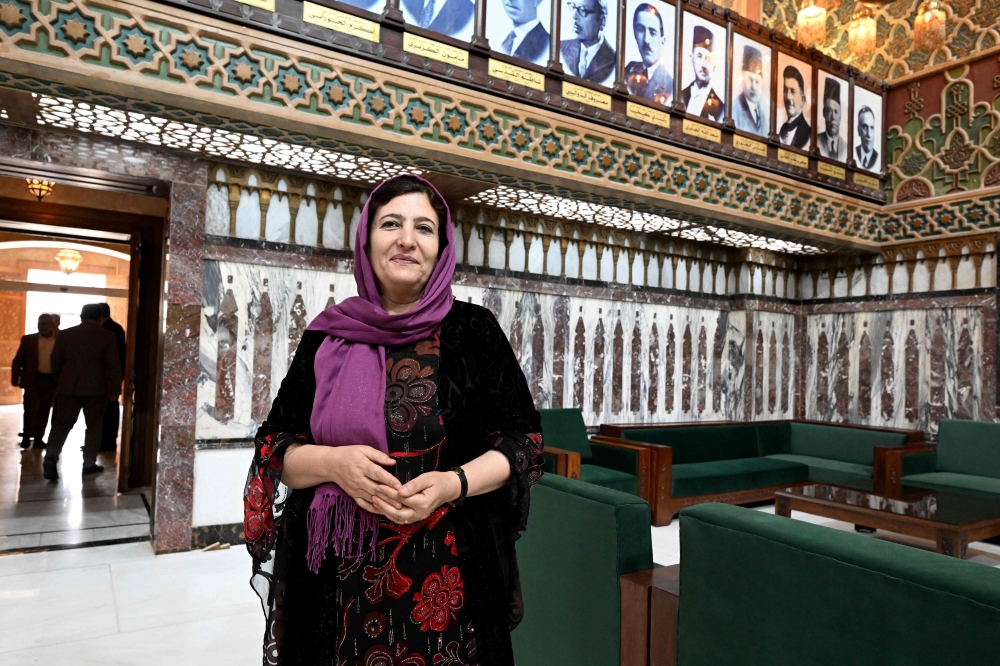 Syria lawmaker Fasla Yousef poses inside parliament in Damascus on July 27, 2026, as a Kurdish leader among the women shaping the country’s first post-Assad assembly. — AFP pic