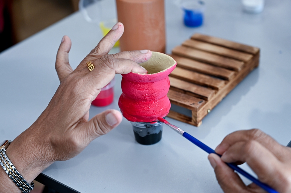 A retiree taking part in an art activity at the centre. — Bernama pic