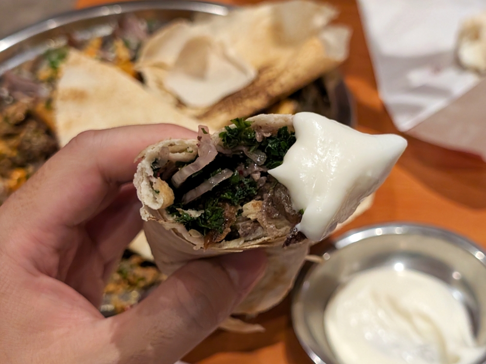 The Beef Shawarma Wrap balances fat and meat with onions, tomatoes, parsley and ‘tahini’. — Picture by Ethan Lau
