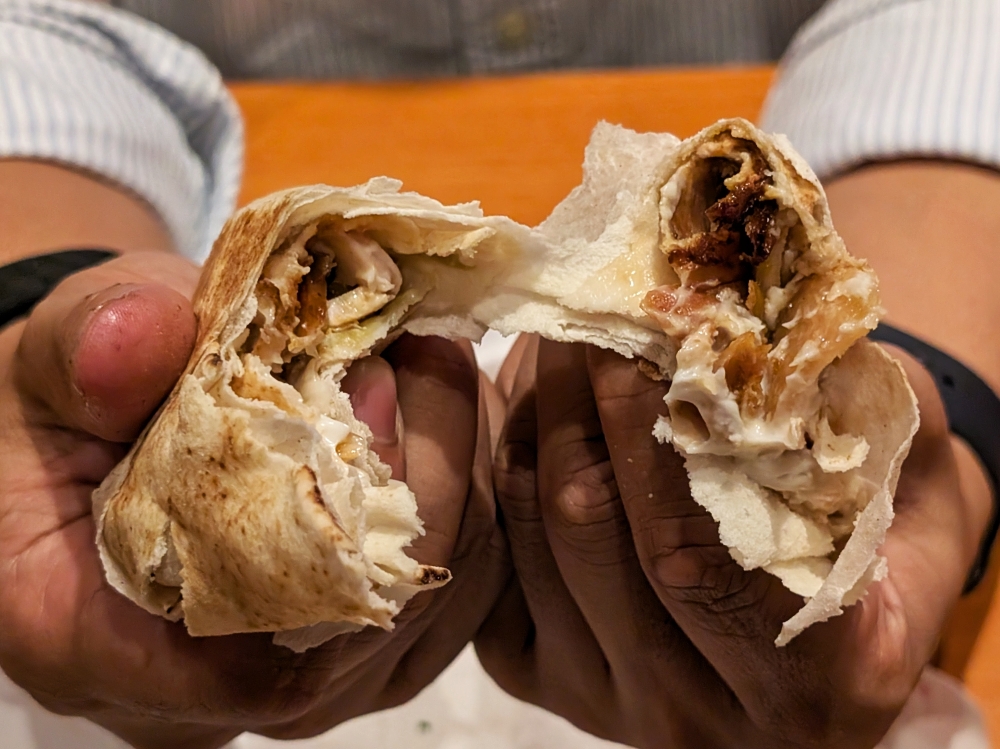 The Chicken Shawarma Wrap is modestly filled with garlic sauce and chicken. — Picture by Ethan Lau