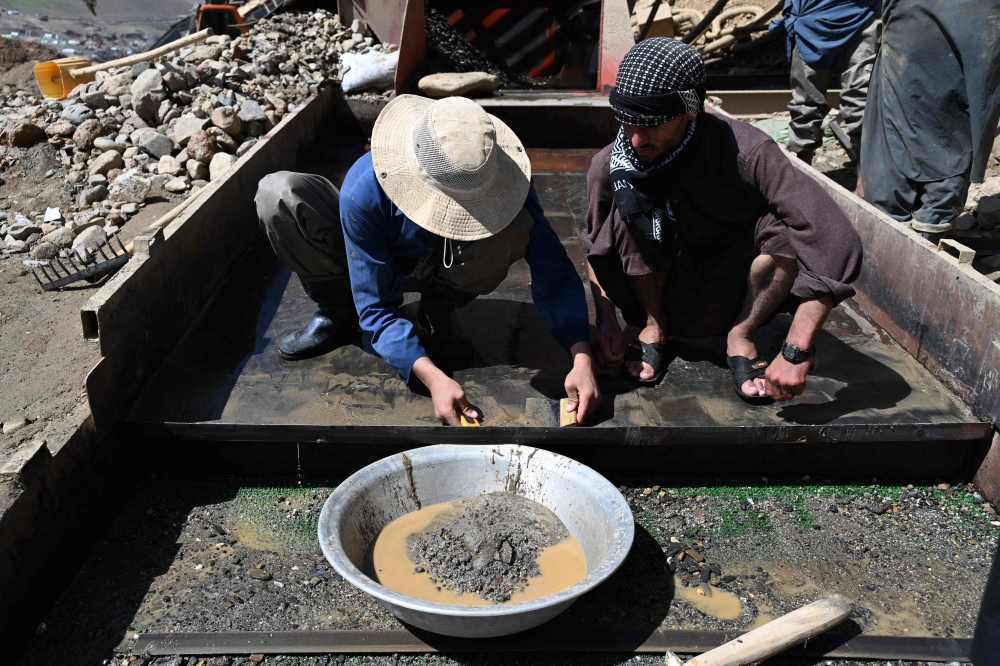 This photograph taken on July 28, 2026 shows Afghan miners extracting gold at Gulak-Dara valley in Shiwa area of Afghanistan's northeastern Badakhshan province. In Afghanistan's northeastern Badakhshan province, dozens of excavators operate day and night to extract gold from the mountains where villagers and their livestock once roamed. — AFP pic