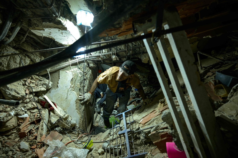 Marcel Hernandez takes part in the recovery of bodies from the rubble of a building that collapsed during the earthquake of June 24, in La Guaira, Venezuela, on August 6, 2026. — AFP pic Marcel Hernandez takes part in the recovery of bodies from the rubble of a building that collapsed during the earthquake of June 24, in La Guaira, Venezuela, on August 6, 2026. — AFP pic