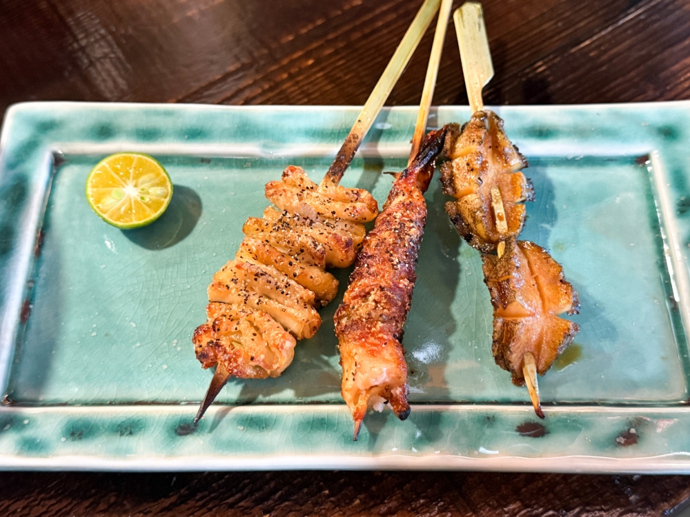 The sticks (from left to right) feature Shiso Chicken Skin, Salt Grilled Prawn and Sauce Grilled abalone. — Picture by Lee Khang Yi