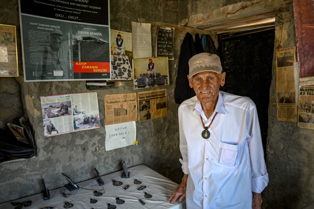 Mehmet Kusman, aged 86, who speaks Urartian language, poses at his workshop at the fortress of Cavustepe near Van, in eastern Turkey, on July 22, 2026. Mehmet Kusman, 86, has dedicated his life to the Cavustepe Fortress in eastern Turkey and to studying the Urartian language, which borrows its cuneiform alphabet from Assyrian to honour the gods and rulers of the lost kingdom. — AFP pic