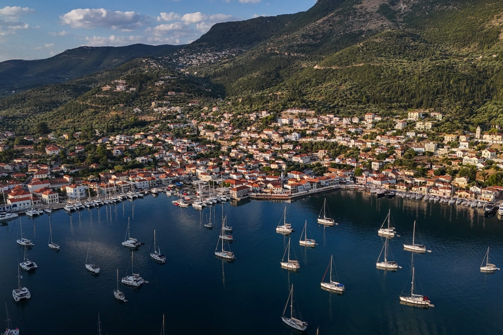 This photo taken on August 4, 2026, shows an aerial view of the town of Vathy on the island of Ithaca. Ithaca, the home to the hero Odysseus in Homer's Odyssey, is far from Greece's main tourist hubs it has never been a regular stop for travellers. The release of the blockbuster film The Odyssey has the island's businesses and officials expecting a rise touristic activity. — AFP pic