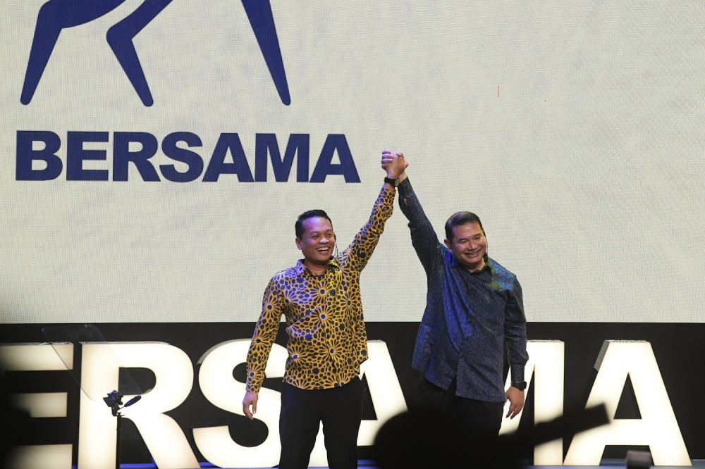 (From left) Nik Nazmi Nik Ahmad and Datuk Seri Rafizi Ramli raise their hands together on stage during the official launch of the new political branding, Bersama, at the PJ Performing Arts Centre in Petaling Jaya on May 17, 2026. — Picture by Raymond Manuel