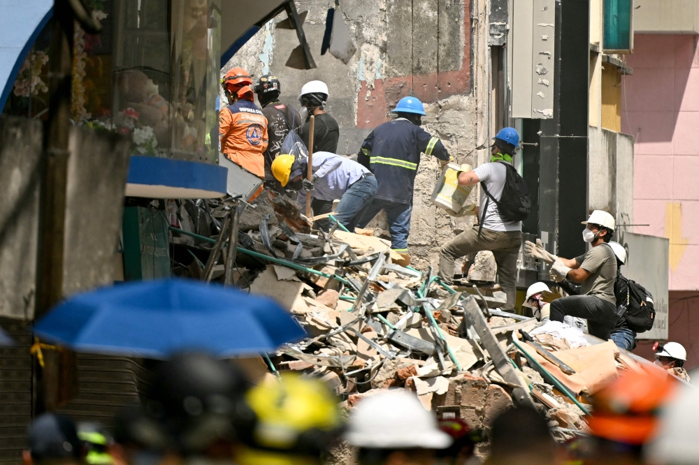 Rescuers search for survivors amid the rubble of a collapsed building four days after a 7.4 earthquake in Pereira, Colombia on August 14, 2026.  — AFP pic