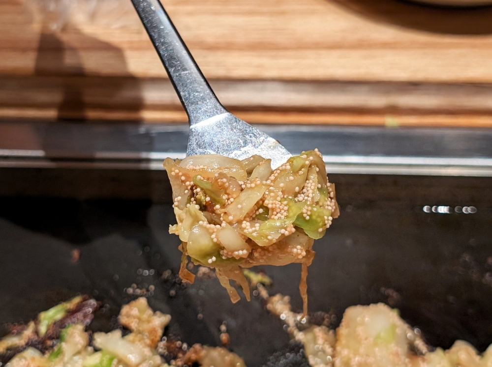 ‘Monjayaki’ is eaten with small metal spatulas, which can be used to scoop up the gooey mixture (as pictured here) or press the mixture onto the griddle to caramelise further.— Picture by Ethan Lau
