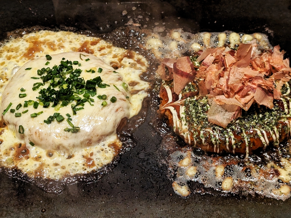 ‘Okonomiyaki’ may be slightly more put together, but they are no less messy on the griddle than ‘monjayaki’.— Picture by Ethan Lau
