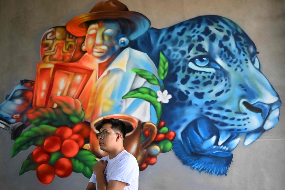 Salvadoran artist and Pigmentrip festival founder Isaac Sosa, 31, gestures during an interview within the eighth edition of the PigmenTrip Muralism Festival -part of the local Festival del Jaguar- in Concepcion de Ataco, Ahuachapan, El Salvador, on August 15, 2026. — AFP pic