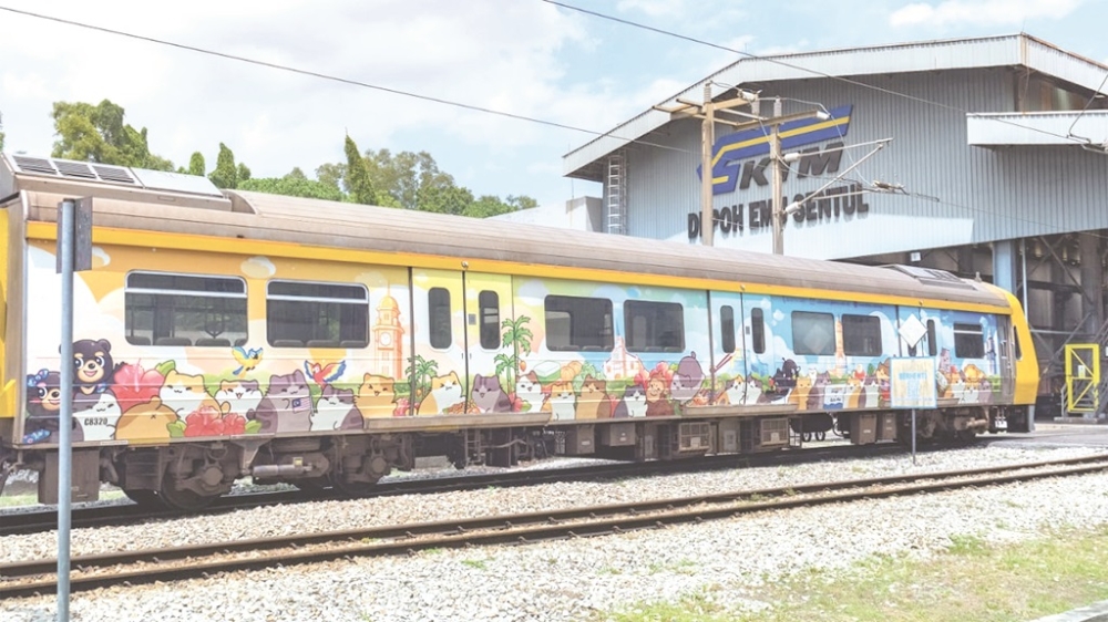 A KTMB train carriage with Olive Yong’s Bichi Mao cat characters decorating the side is seen at the depot in Sentul, Kuala Lumpur. ­— Picture courtesy of Bichi Mao Team via Daily Express
