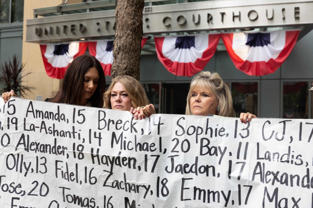 Lisa Pearson, Victoria Hinks and Lori Schott hold a banner displaying names of people who allegedly died from the impacts of social media outside the Ronald V. Dellums Federal Building and U.S. Courthouse in Oakland, California on August 18, 2026. — AFP pic