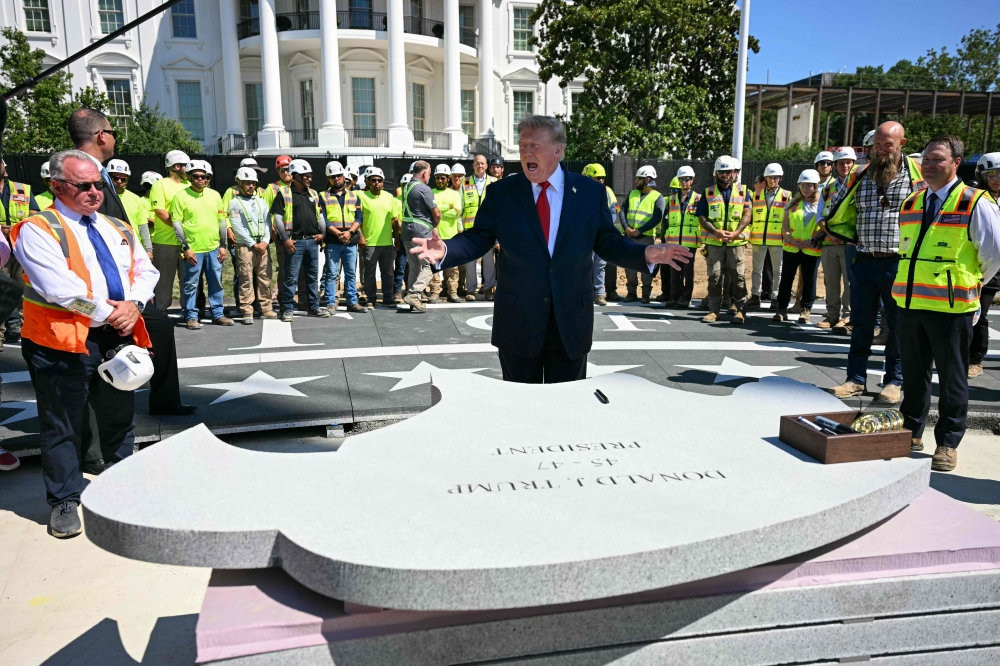 US President Donald Trump speaks before signing a piece of stone at the construction site of a helipad on the South Lawn of the White House in Washington, DC, on August 19, 2026. — AFP pic