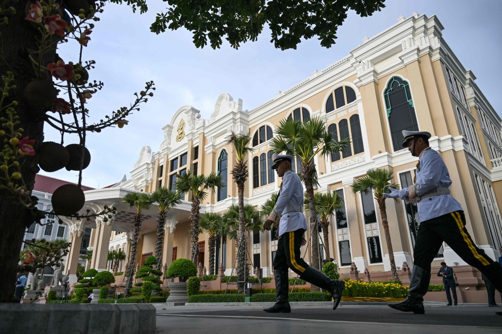 Members of the honour guard walk in front of the new Senate building, known as Solidarity Palace, during its inauguration ceremony in Phnom Penh August 21, 2026. — AFP pic