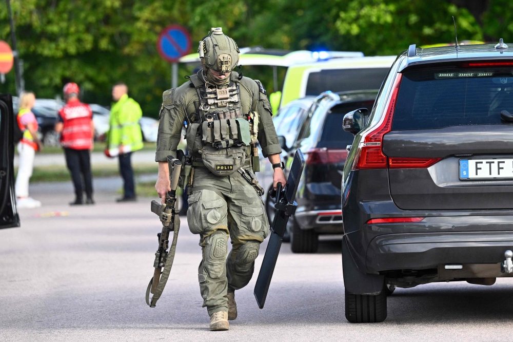 Police special forces work at the scene after a sword-wielding attacker wounded several people at Brinellskolan high school in Fagersta, central Sweden, on August 21, 2026. — AFP pic