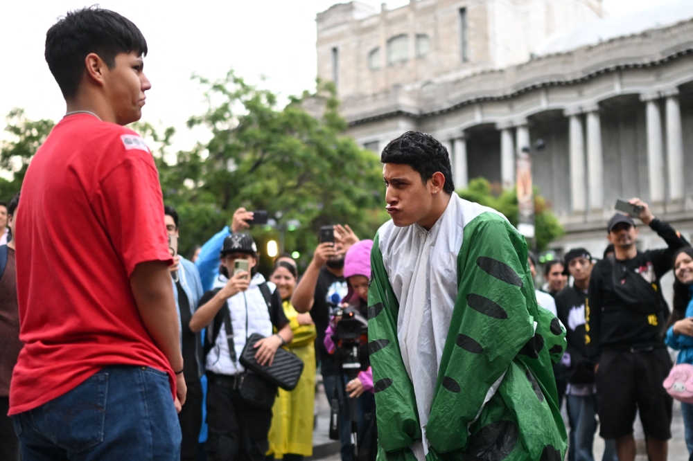 Two teenagers are limbering up for battle. — AFP pic
