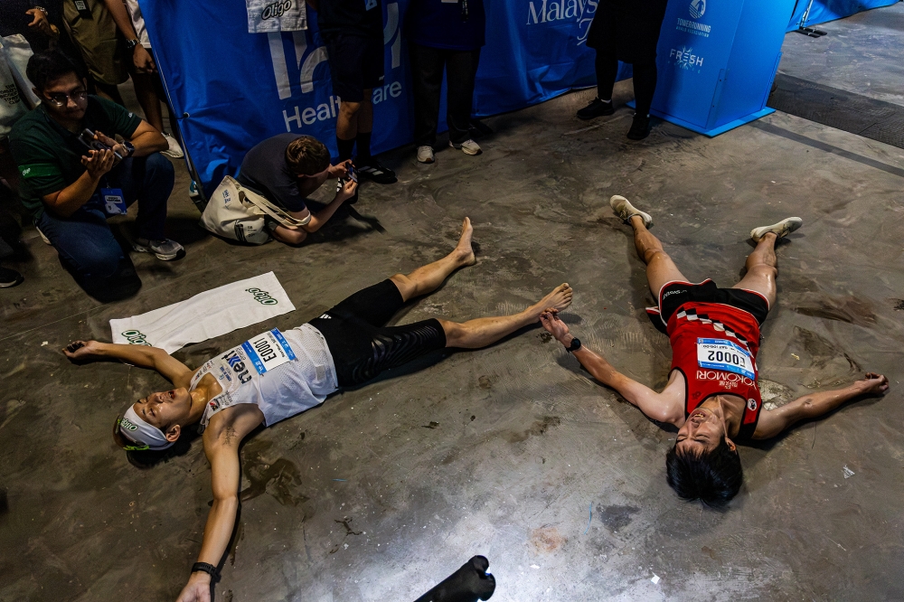 IHH Sky Race winner Ryoji Watanabe (right) and runner-up Soh Wai Ching (left) catch their breath after scaling 118 floors in 15 minutes at Merdeka 118 in Kuala Lumpur on August 22, 2026. — Picture by Firdaus Latif