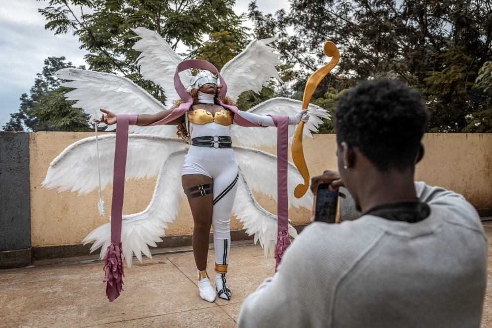 Cosplayer Yvonne Chockey creates content with a friend for her social media accounts while cosplaying as Angewomon, a character from the popular Digimon anime series, ahead of the Otamatsuri convention at the rooftop of her home in Kutus on August 17, 2026. — AFP pic