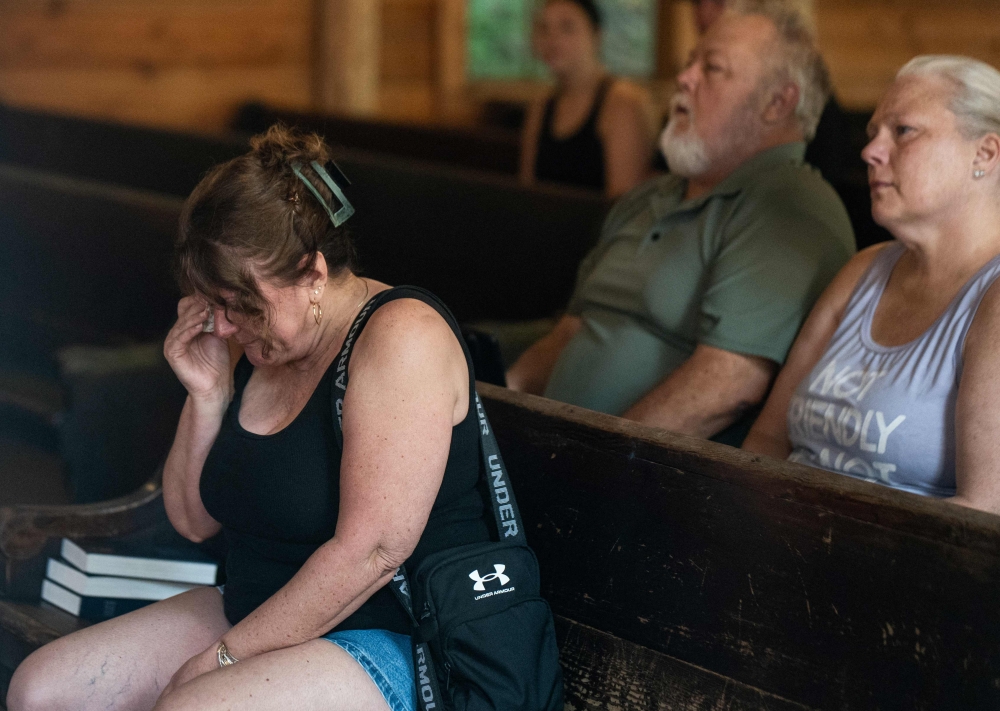 People have a quiet moment as they sit inside the Robert F. Thomas Chapel at the Dollywood theme park in Pigeon Forge, Tennessee on August 26, 2026. — AFP pic