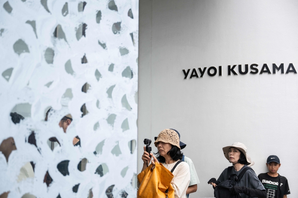 Visitors line up outside the Yayoi Kusama Museum in Tokyo August 27, 2026. — AFP pic