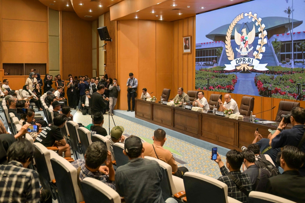 Indonesia’s House of Representatives deputy speakers Cucun Ahmad Syamsurijal (left), Sufmi Dasco Ahmad (centre) and Saan Mustofa (right) listen to protesters’ grievances at the parliament building in Jakarta on August 27, 2026, following a demonstration demanding an asset forfeiture law for corrupt officials. — AFP pic