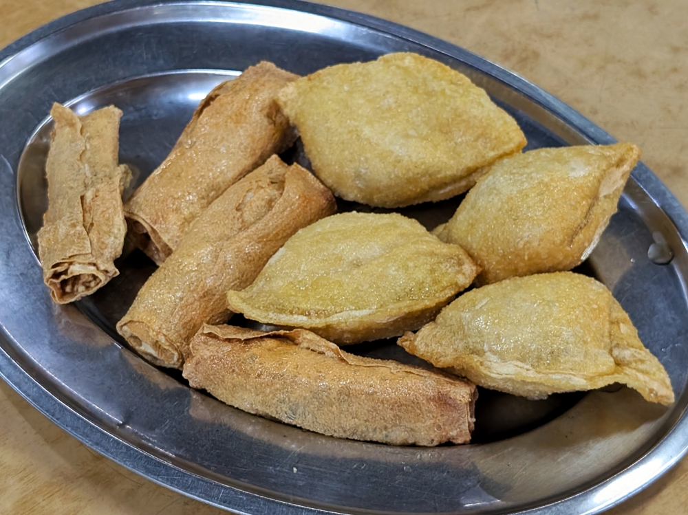 The signature fried beancurd comes in two shapes: a beancurd skin roll and a ‘wonton’ the size of a cream puff — Picture by Ethan Lau