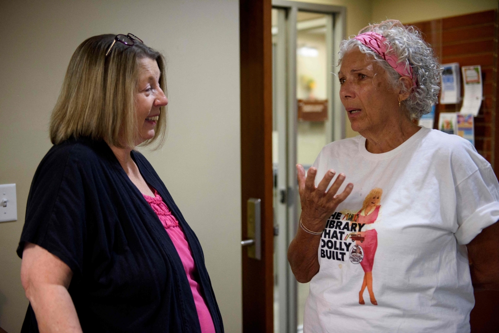 Sevier County Public Library System director Rhonda Tippitt (left) and Vera Peters discuss Dolly Parton’s impact on their lives at the King Family Public Library in Sevierville, Tennessee, on August 26, 2026.