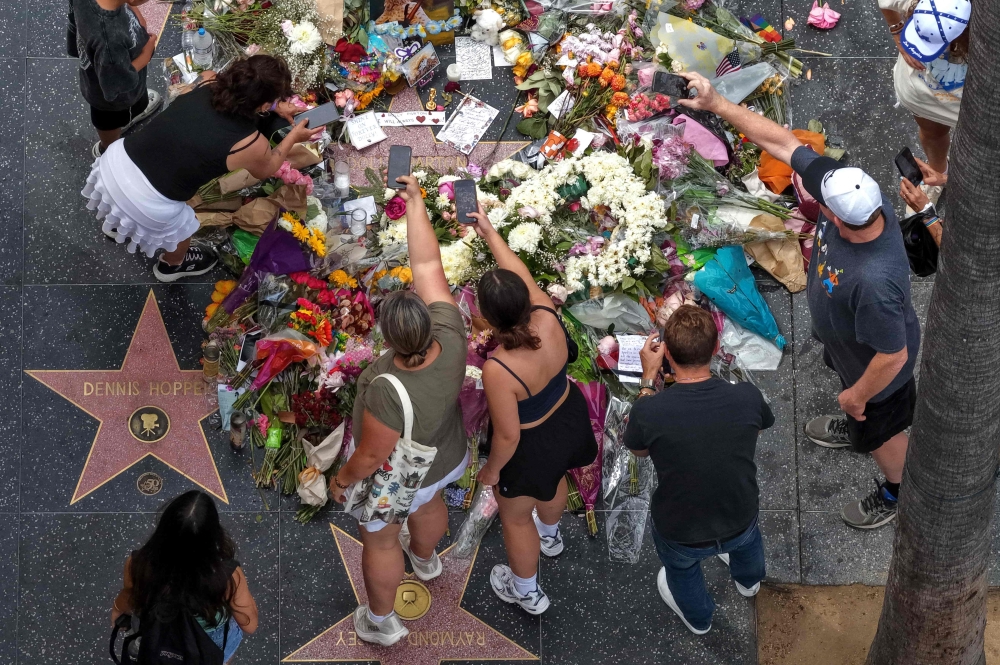 Flowers and tributes surround Dolly Parton’s star on the Hollywood Walk of Fame in Los Angeles, California, on August 27, 2026. — AFP pic