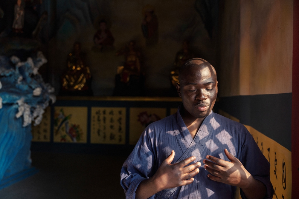 Shaolin Monk Ronald Mwale gestures as he stands in front of the shrine at a Shaolin Temple outside Lusaka, on August 8, 2026. — AFP pic