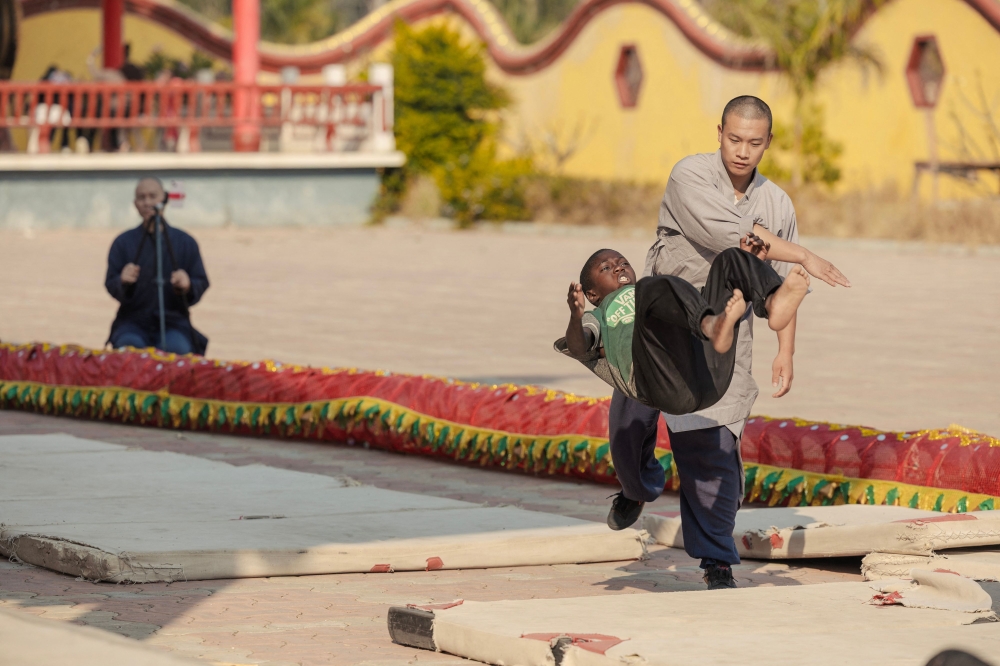 Shaolin monk Yan Chen helps student to somersault during a training session at a Shaolin Temple outside Lusaka, on August 8, 2026. — AFP pic