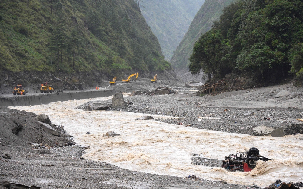 Repair work has been paused along a road leading to Gyirong Port after a mudslide damaged it in Gyirong County, western Tibet, on August 28, 2026, amid the threat of new flooding. — AFP pic