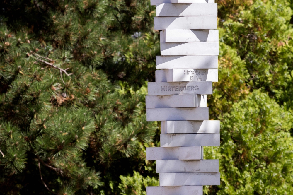 A stele commemorating and listing the names of about 40 subcamps of the Mauthausen concentration camp stands in Hirtenberg, Austria, on August 22, 2026, near the site of a former Nazi forced labour complex facing development. — AFP pic