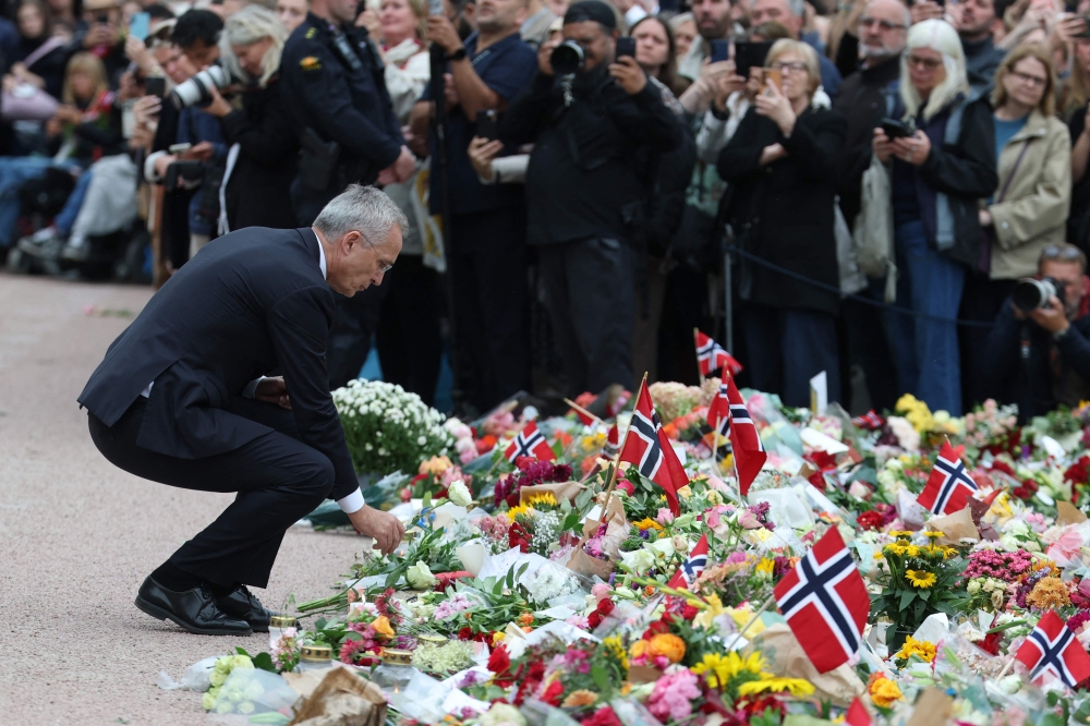 Norway’s Finance Minister Jens Stoltenberg lays a bunch of flowers outside the royal palace as mourners pay tribute after King Harald V of Norway passed away in Oslo, Norway on August 28, 2026. — AFP pic