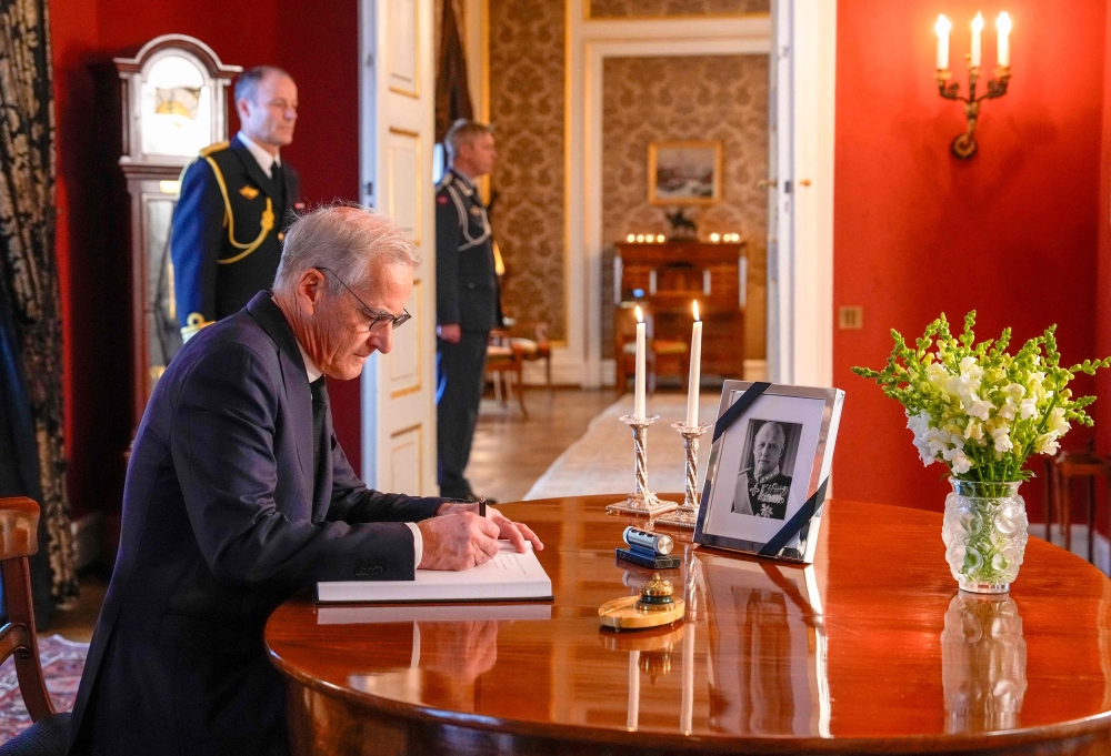 Norway’s Prime Minister Jonas Gahr Store signs the book of condolences at the Royal Palace, in Oslo on August 28, 2026, following the death of King Harald V of Norway. — AFP pic
