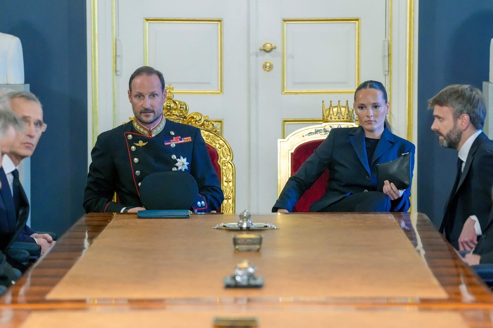 King Haakon of Norway (centre, left) and Princess Ingrid Alexandra of Norway (centre, right) sit at the head of the table during an extraordinary Cabinet meeting at the Royal Palace in Oslo on August 28, 2026, following the death of King Harald V at the age of 89. — AFP pic