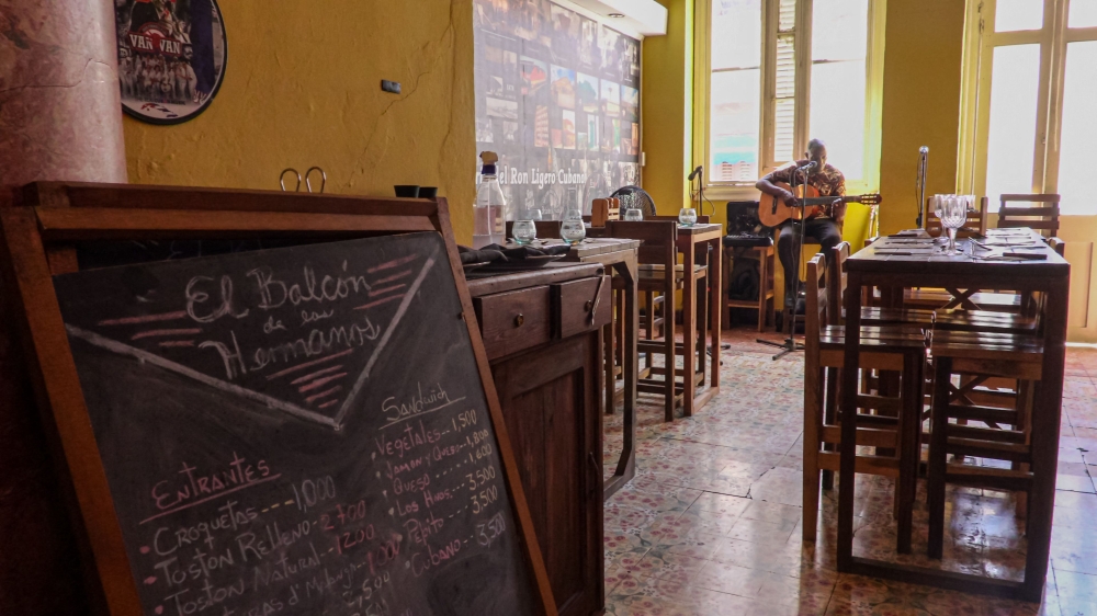 A musician performs beside empty tables at El Balcon de los Hermanos restaurant in Havana on August 22, 2026. — AFP pic