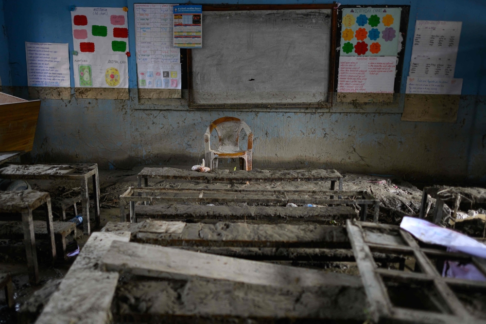 School benches and a teacher’s chair lie buried in mud inside a classroom at Bageshwori Secondary School in Galchi, Nepal’s Dhading district, following flash floods on August 30, 2026. — AFP pic