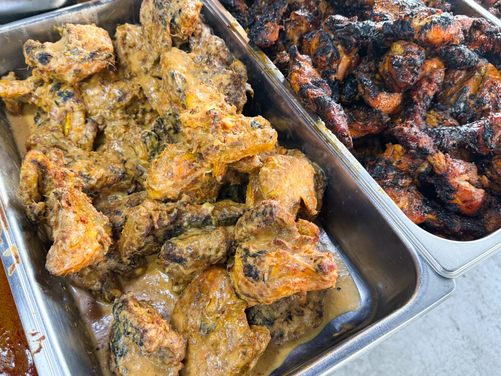 Two versions of ‘ayam percik’ or grilled chicken can be found: one with a mild, creamy sauce and another with a spicier red sauce. — Picture by Lee Khang Yi