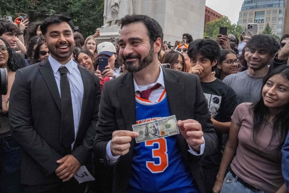 Winner Amadeo Fusca collects his US$100 prize after winning a Zohran Mamdani look-alike contest near Washington Square Park in New York City on August 30, 2026. — Getty Images pic via AFP