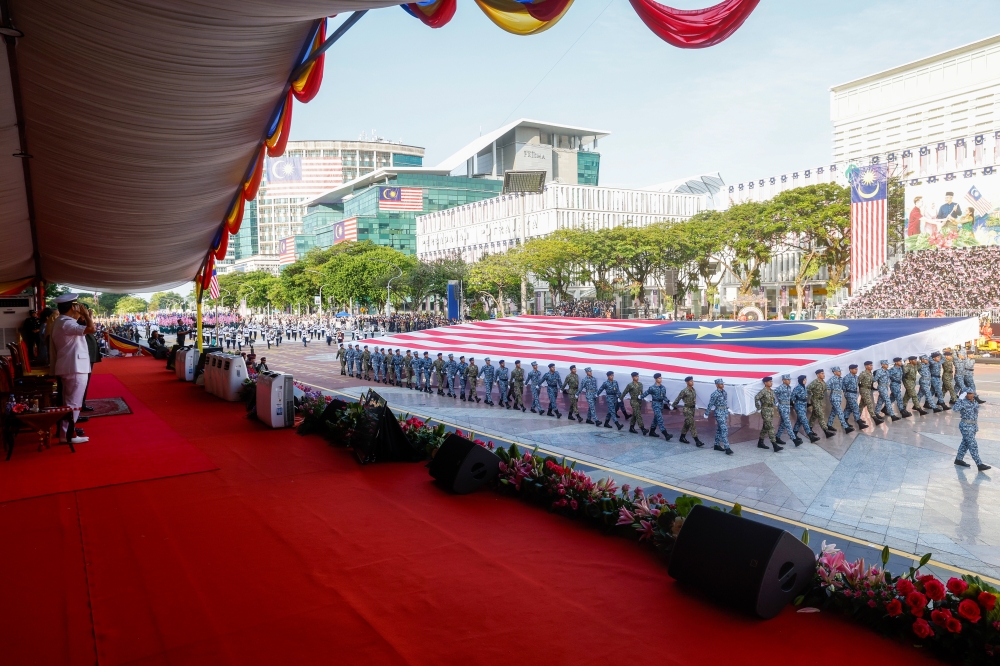 A giant Jalur Gemilang is carried past His Majesty Sultan Ibrahim, King of Malaysia, during the National Day 2026 celebrations at Dataran Putrajaya in Putrajaya August 31, 2026. — Bernama pic